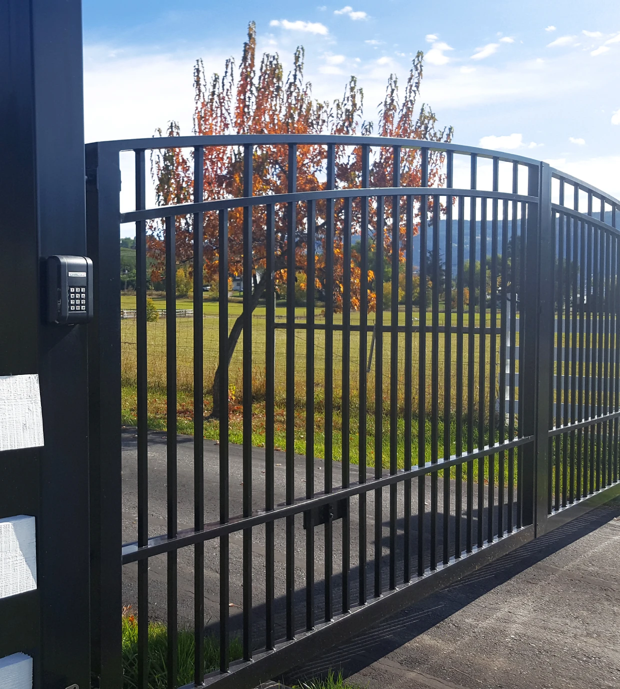 Black gate in rural landscape