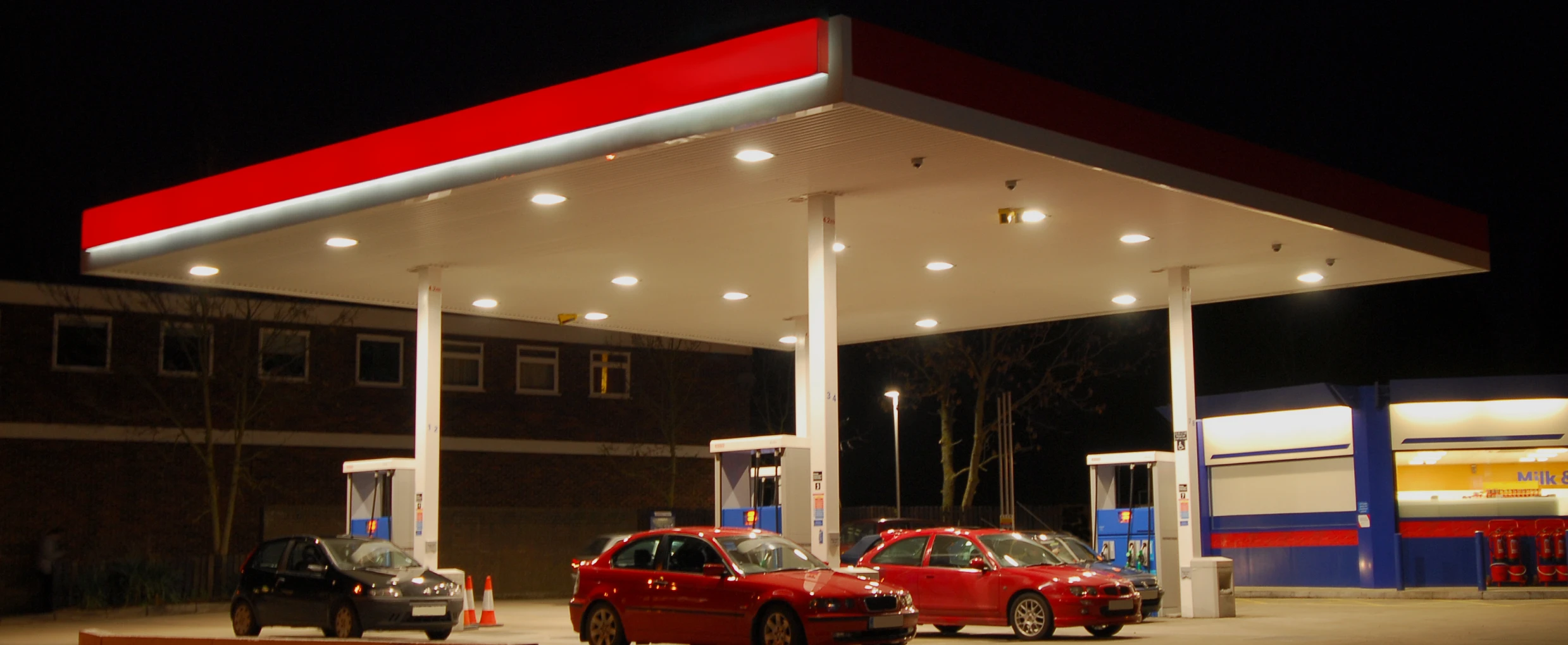Gas station with cars at night