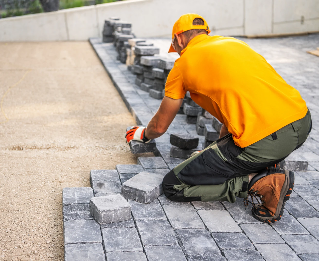 Man installing bricks for pathway construction